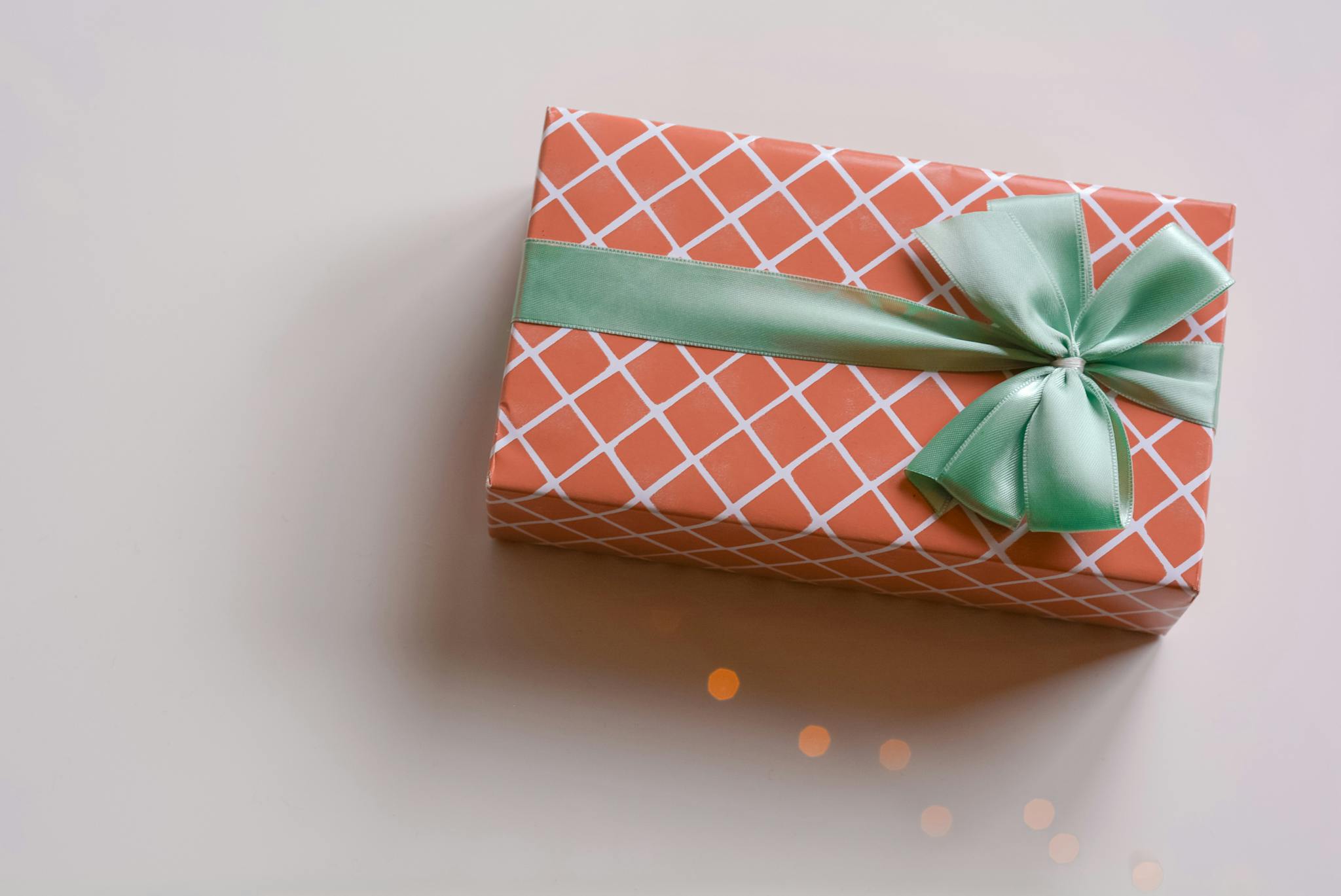 Elegant gift box with patterned wrapping and ribbon bow. Ideal for celebrations.